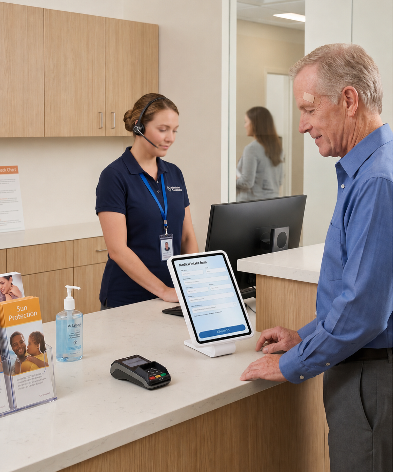 A patient self-checks in on a CONNECT PRO BaseStation iPad kiosk at a dermatology clinic reception counter while a headset-wearing front-desk staffer works behind the desk — the kiosk runs check-in while the front desk handles everything else